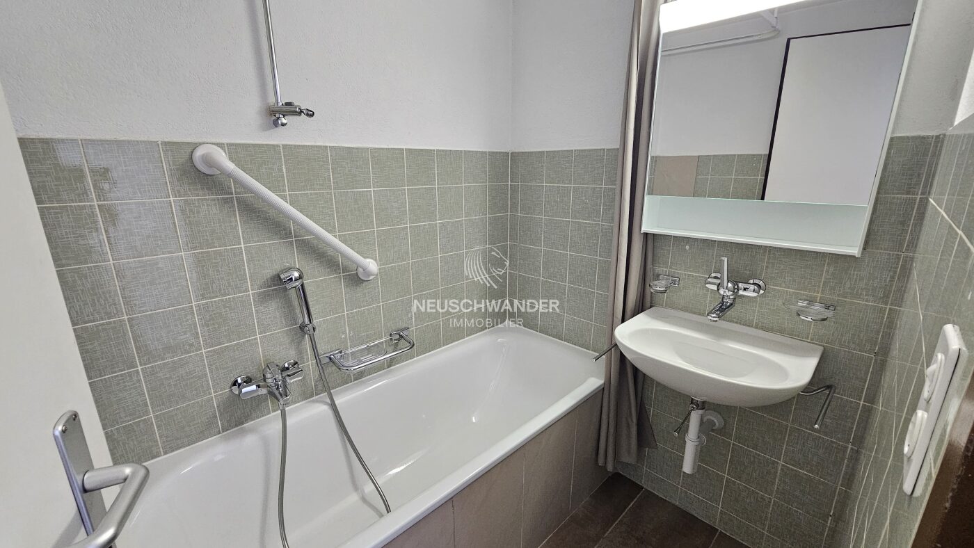 Salle de bains avec baignoire et lavabo